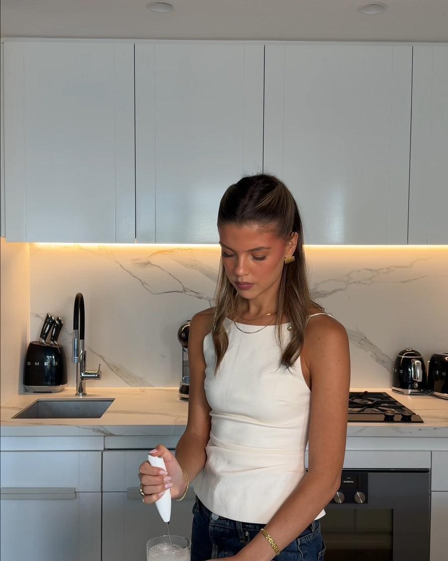 Ella stirring a sachet into water